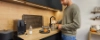A man making coffee in a modern Nolte Kitchen kitchen.