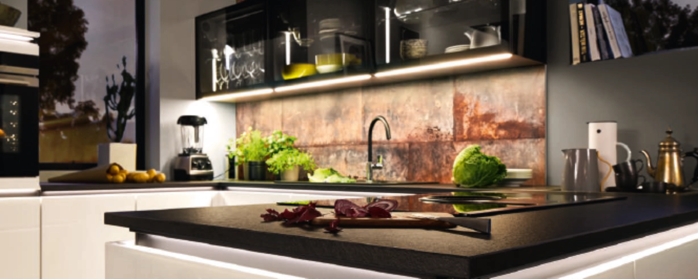 Een moderne keuken met eiland en verlichting, "Nolte Kitchen" staat voor hoogwaardige ontwerpen.