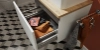 Een open badkamerkast met handdoeken en accessoires, Nolte SPA.