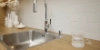 Cuisine moderne avec plan de travail en bois et évier en acier inoxydable de Nolte Kitchen.