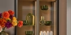 Un élégant placard de cuisine avec étagères en verre et éclairage décoratif, arrangé par Nolte Kitchen.