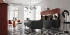 A modern kitchen with a geometric tile floor and a black island by Nolte Kitchen.