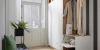 Un hall d'entrée élégant avec penderie, banc et décoration, idéal pour Nolte Living.