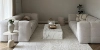 Un salon moderne avec deux canapés et une table en marbre, assortis à Nolte Living.