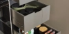 Open kitchen drawers with organized contents in a modern Nolte kitchen.