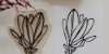 Un tampon gravé avec motif de feuille et l'illustration imprimée sur papier.