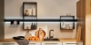Une cuisine moderne avec un plan de travail en bois et des étagères élégantes, conçue par Nolte Kitchen.