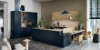 Cuisine moderne avec armoires sombres et accents en bois, conçue par Nolte Kitchen.