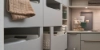 Une buanderie moderne avec des armoires et étagères grises de Nolte Utility Rooms.