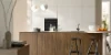 A modern kitchen with wood fronts and pendant lights. Nolte Küchen.