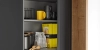 Un placard de cuisine ouvert avec vaisselle et aliments, conçu par Nolte Kitchen.