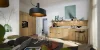 A modern kitchen with wood fronts and stylish lighting, dining table in the foreground. Nolte Kitchens.