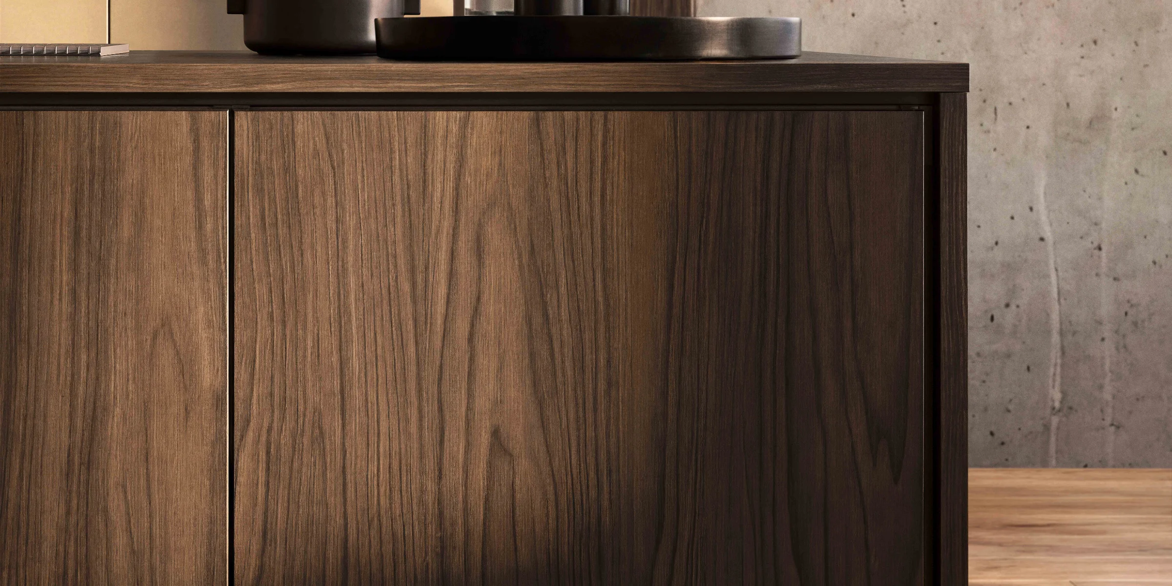 A stylish kitchen with dark wood elements and elegant accessories. Nolte Kitchens.