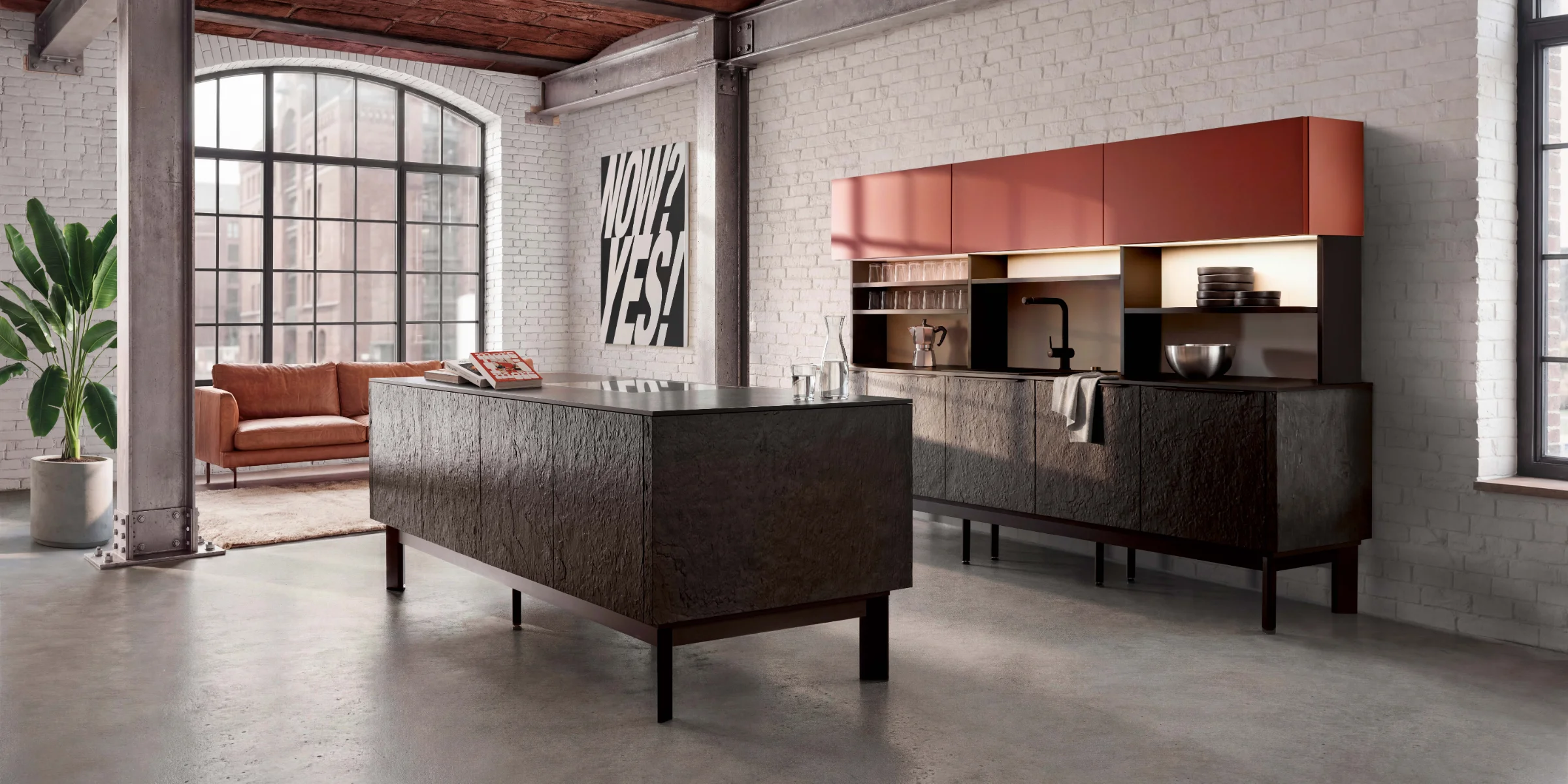 A modern kitchen with an island and brick wall, Nolte Küchen.