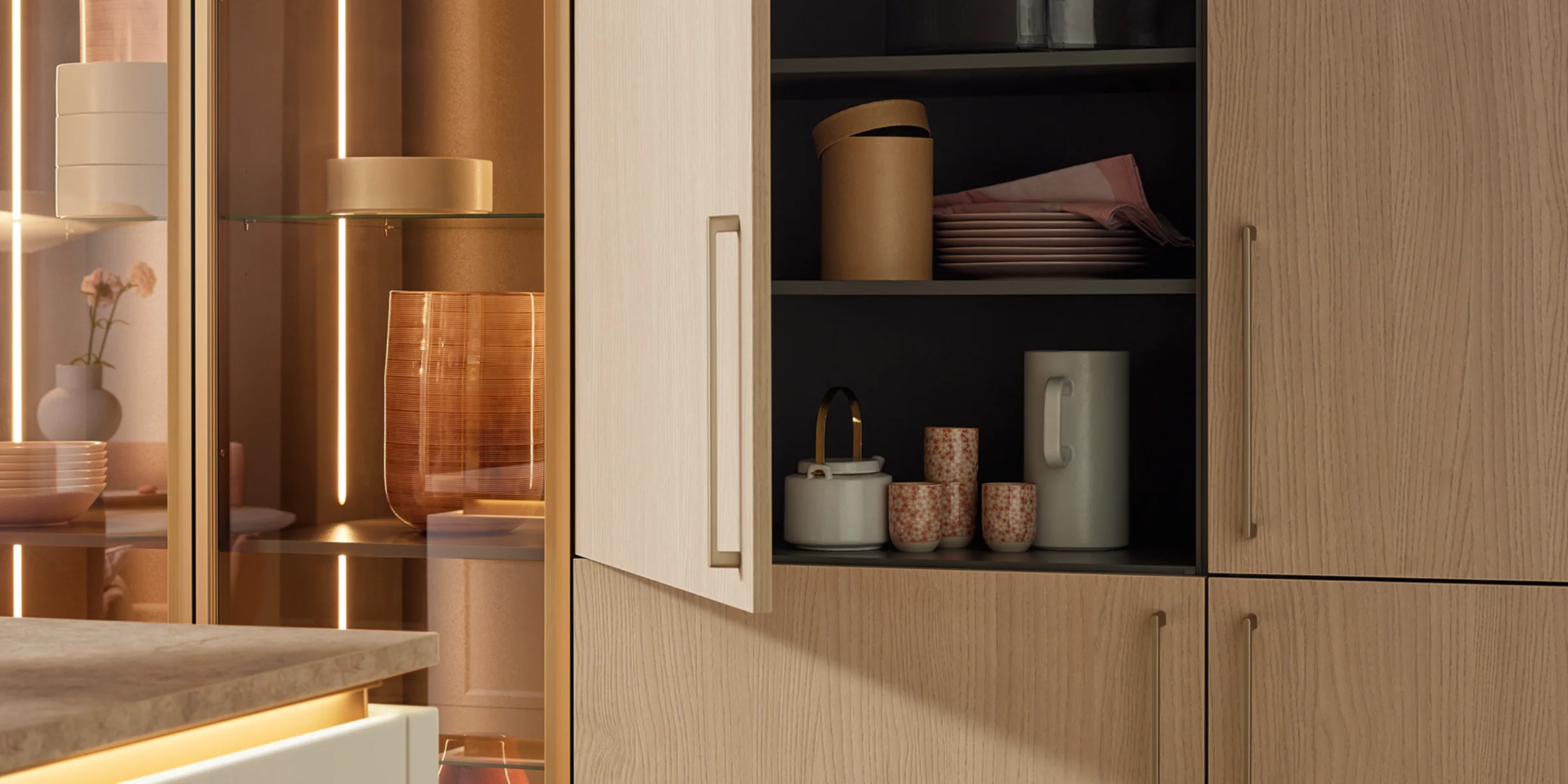 Hoge kast met uittreksysteem in een moderne keuken, voorzien van fronten uit het Nolte Küchen-frontassortiment Soft Lack in de uitvoering Wit Softmatt. De kast bevat een ingebouwde oven en een zijdelings uittrekbare voorraadkast met metalen manden, ideaal voor het bewaren van levensmiddelen. Het matte, greeploze front zorgt voor een minimalistisch, elegant ontwerp in een eigentijdse sfeer.