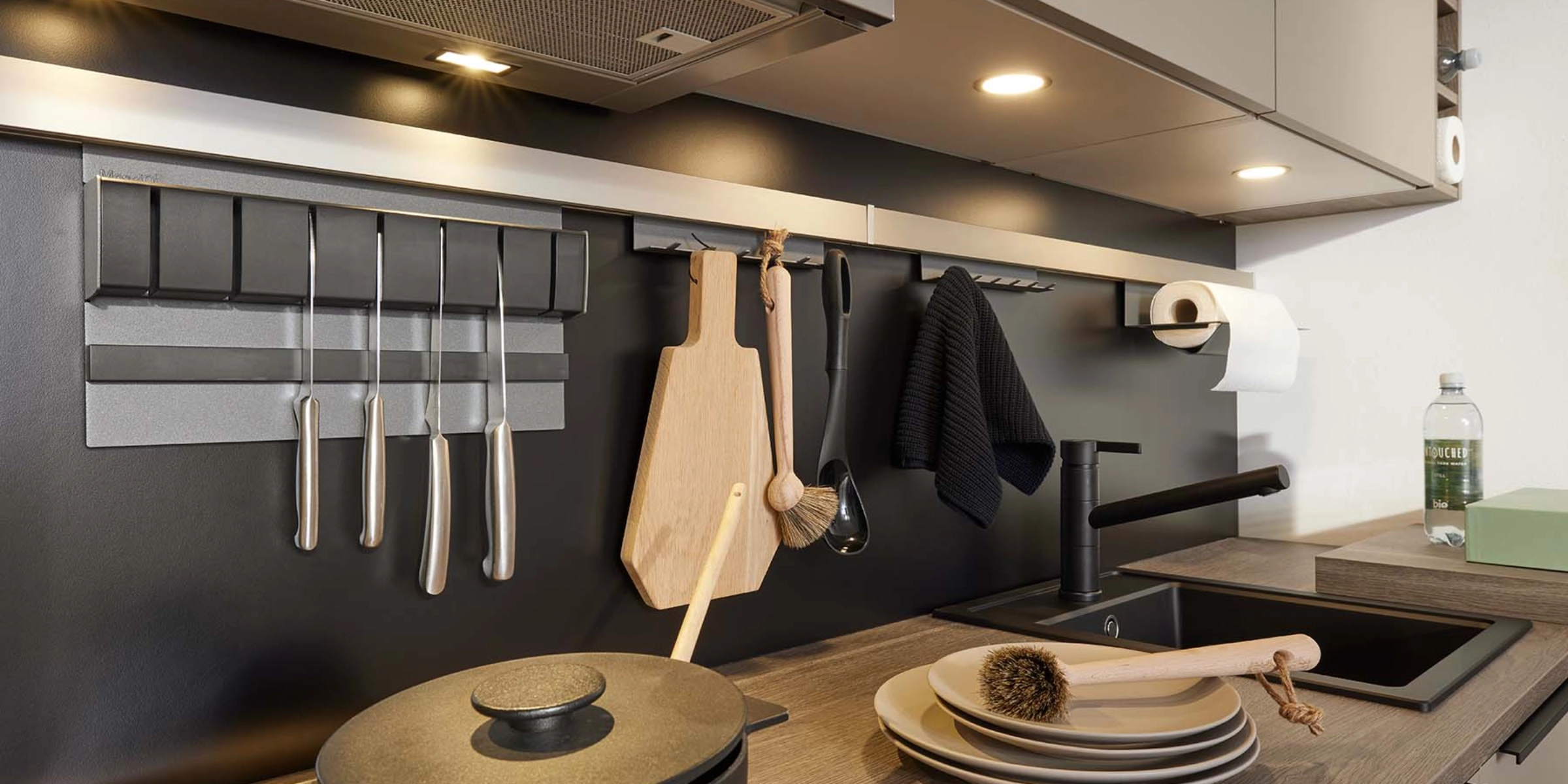 A modern kitchen with cooking utensils and sink, designed by Nolte Kitchen.