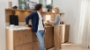 Un homme et une femme discutent dans une cuisine moderne avec des placards en bois de Nolte Kitchen.