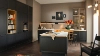 A modern kitchen with dark cabinets and a central island by Nolte Kitchen.