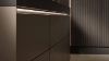 Cuisine moderne avec armoires sombres élégantes et éclairage de Nolte Kitchen.