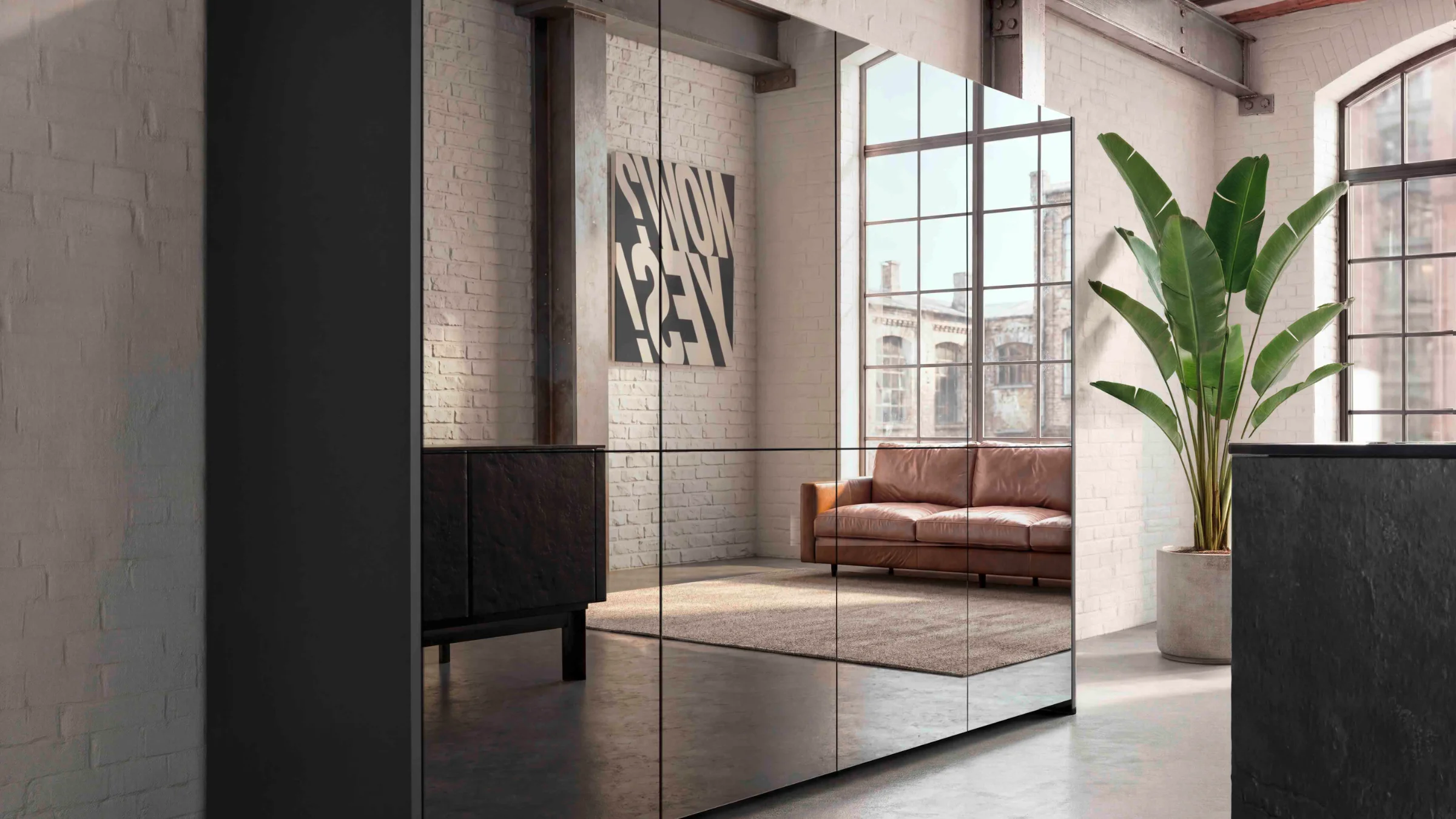 Moderne Loft-Wohnung mit Spiegelwand, grauem Schrank und Ledersofa. nolteneo.