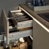 Cuisine moderne avec tiroirs éclairés et plan de travail en bois, design présenté par Nolte Kitchen.