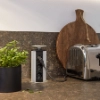 Une cuisine moderne avec grille-pain et herbes aromatiques sur le plan de travail, présentée par Nolte Kitchen.