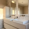 A modern bathroom with double sinks and a large mirror, part of the Nolte SPA.