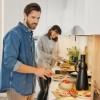 Un couple prépare des plats dans une cuisine moderne de style Nolte.