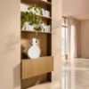 A stylish room with a shelf, vase, and plants. Nolte Living.