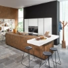 A modern kitchen with an island and bookshelf, designed by Nolte Kitchen.
