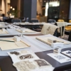 Dans une pièce élégante, des tables avec des matériaux créatifs et des chaises sont disposées, dans le contexte de Nolte Living.
