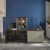 A modern kitchen with a blue wall and island. Nolte Küchen.