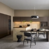 A modern kitchen with dark cabinets and an island; Nolte kitchen design.