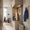 A modern entryway with a mirror and shoe cabinet by Nolte Living.