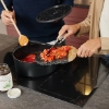 Deux personnes cuisinent ensemble dans une cuisine moderne Nolte.