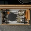 Un tiroir de cuisine ouvert avec des casseroles et poêles, partie de Nolte Kitchen.