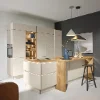 A modern, bright kitchen with an island and stylish lighting. Nolte Kitchens.