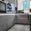 Eine moderne Küche mit grauen Schränken und Geräten, Nolte Küchen.