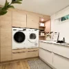 A modern utility room with a washer and dryer, designed by Nolte Utility Rooms.