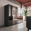 Modern loft apartment with mirror wall, gray cabinet, and leather sofa. Nolte Living.