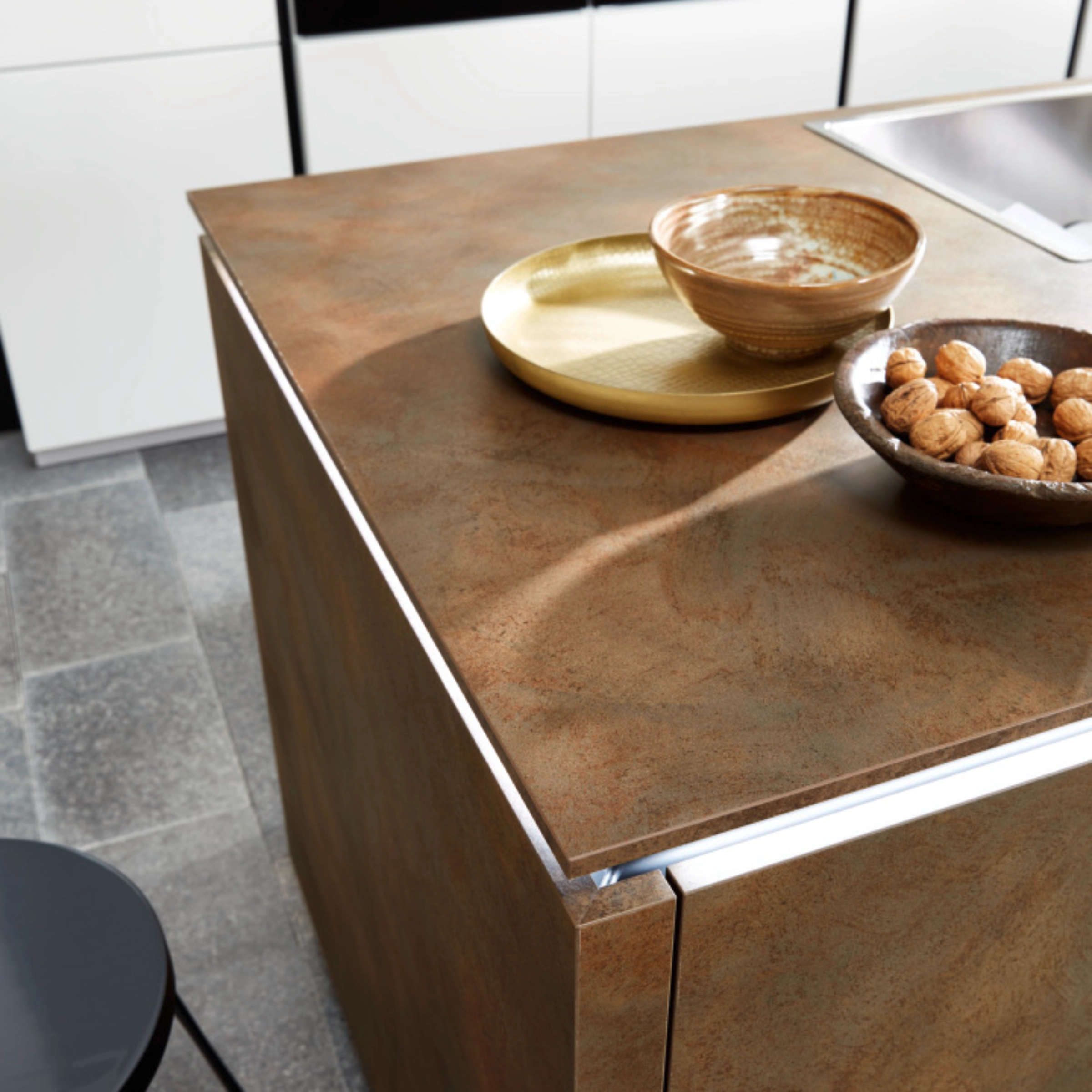 A modern kitchen with a wood-look island and integrated sink by Nolte Kitchen.