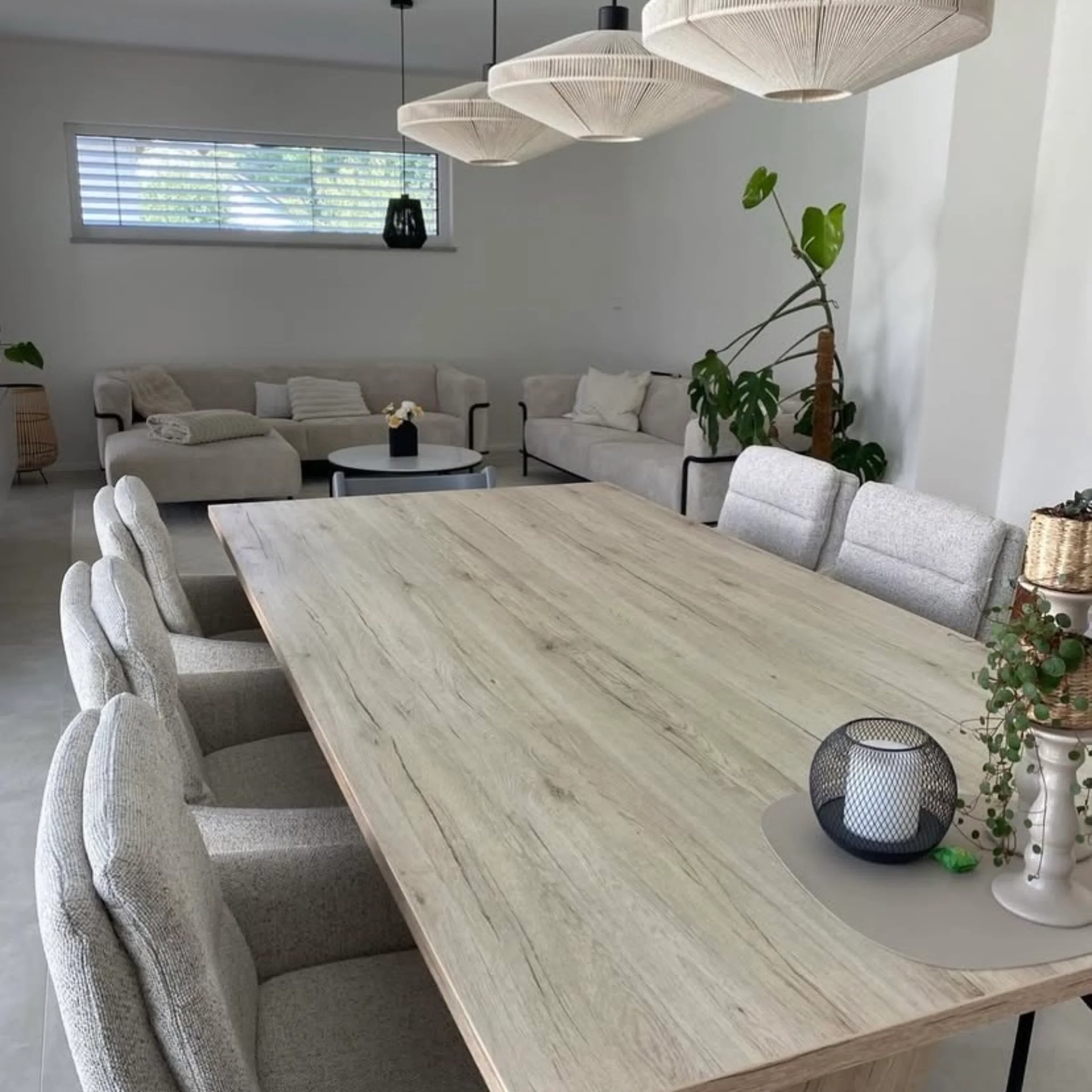 Elegancki salon z dużym stołem jadalnym i stylowymi meblami do siedzenia, Nolte Living.