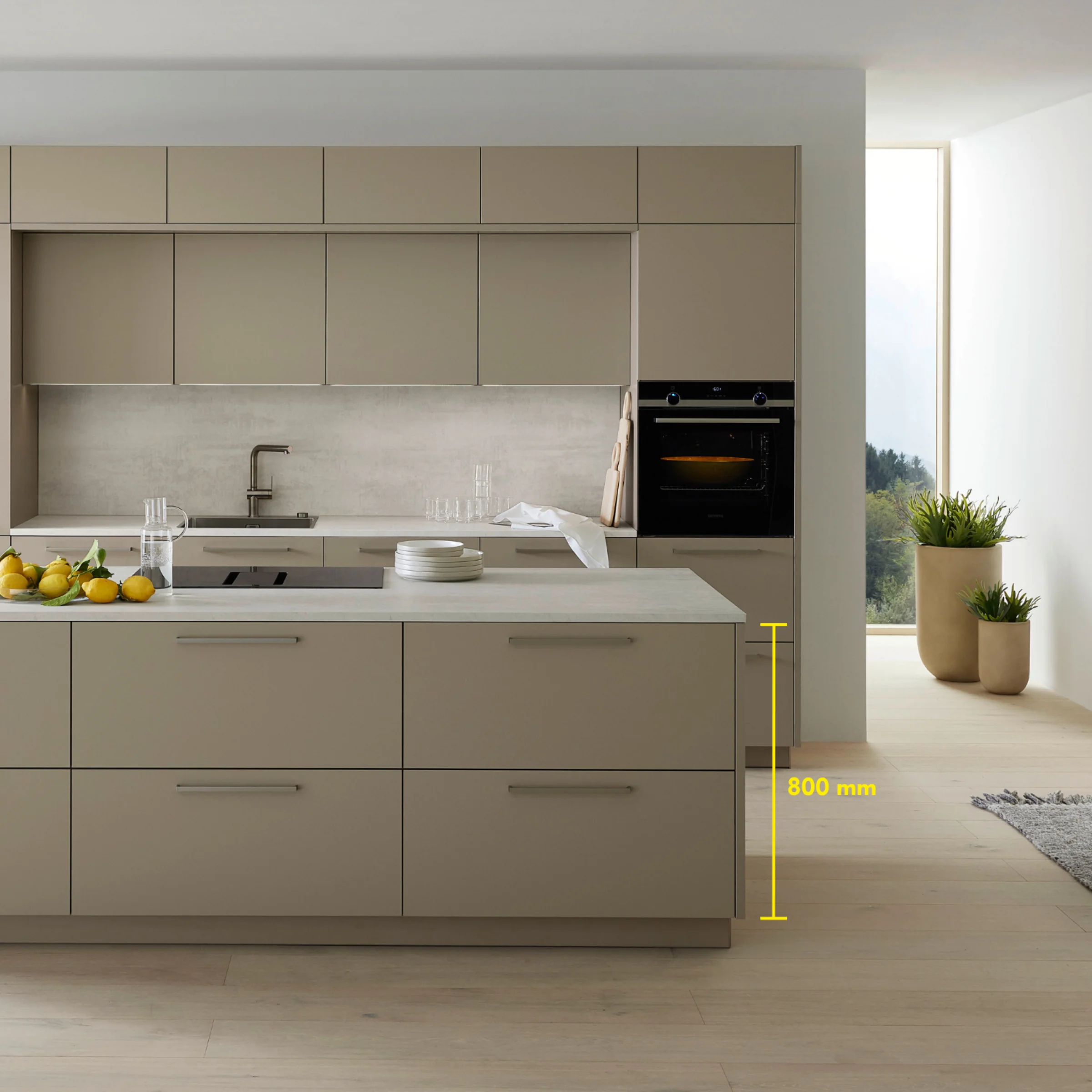 Een moderne keuken met eiland en beige fronten, gepresenteerd door Nolte Kitchen.