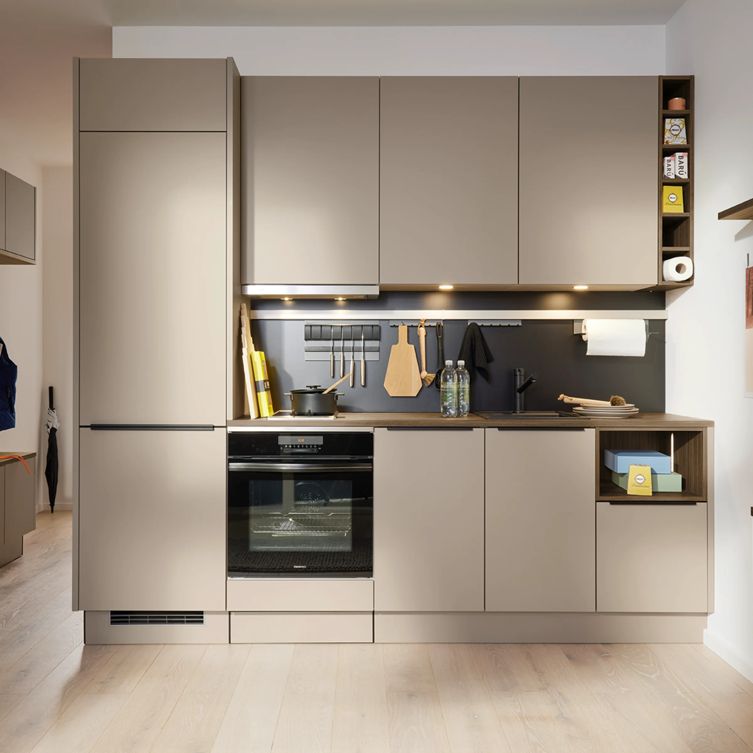 Modern kitchen with beige cabinets and black accents; Nolte Kitchen.