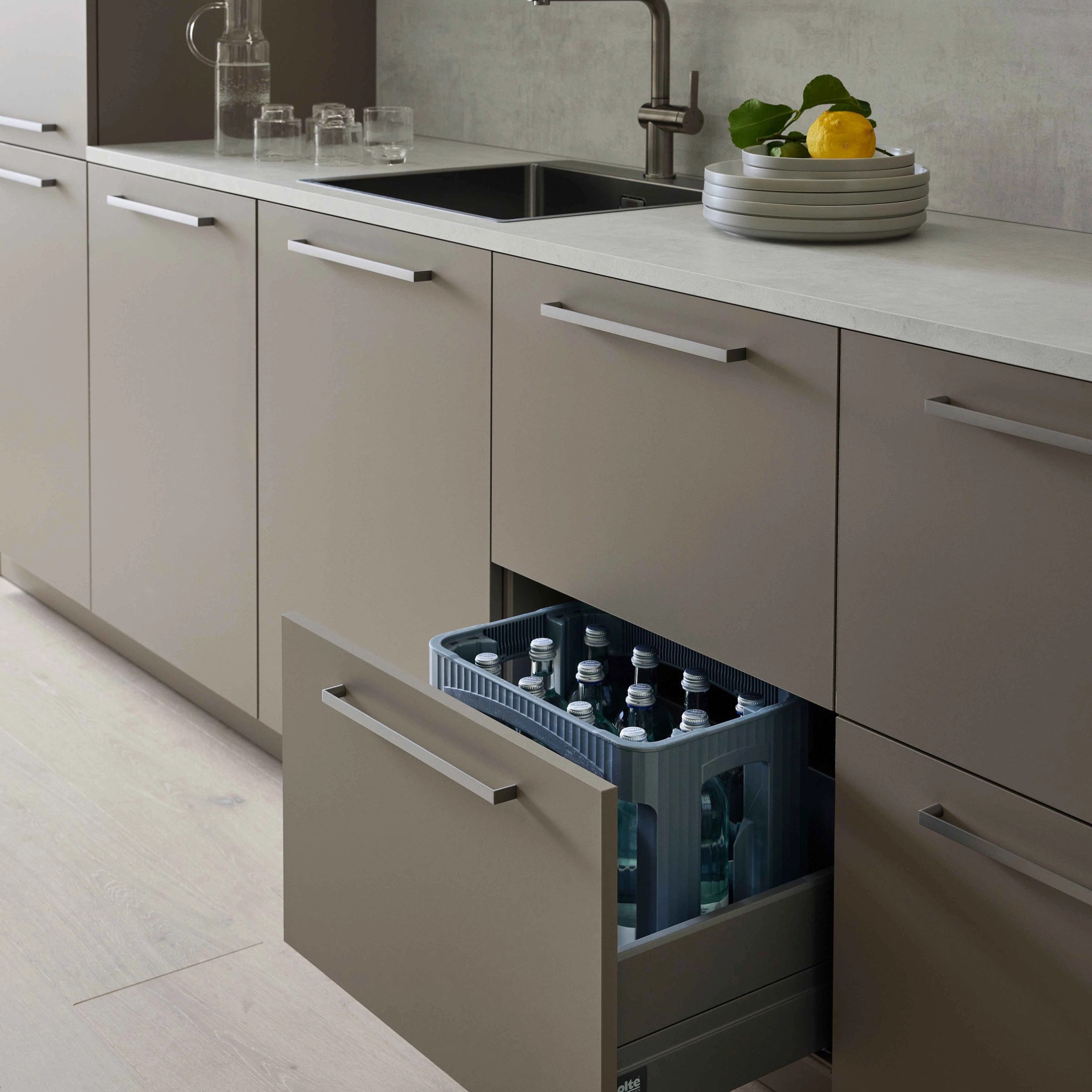 Modern kitchen with open cabinet filled with drinks. Nolte Kitchen.