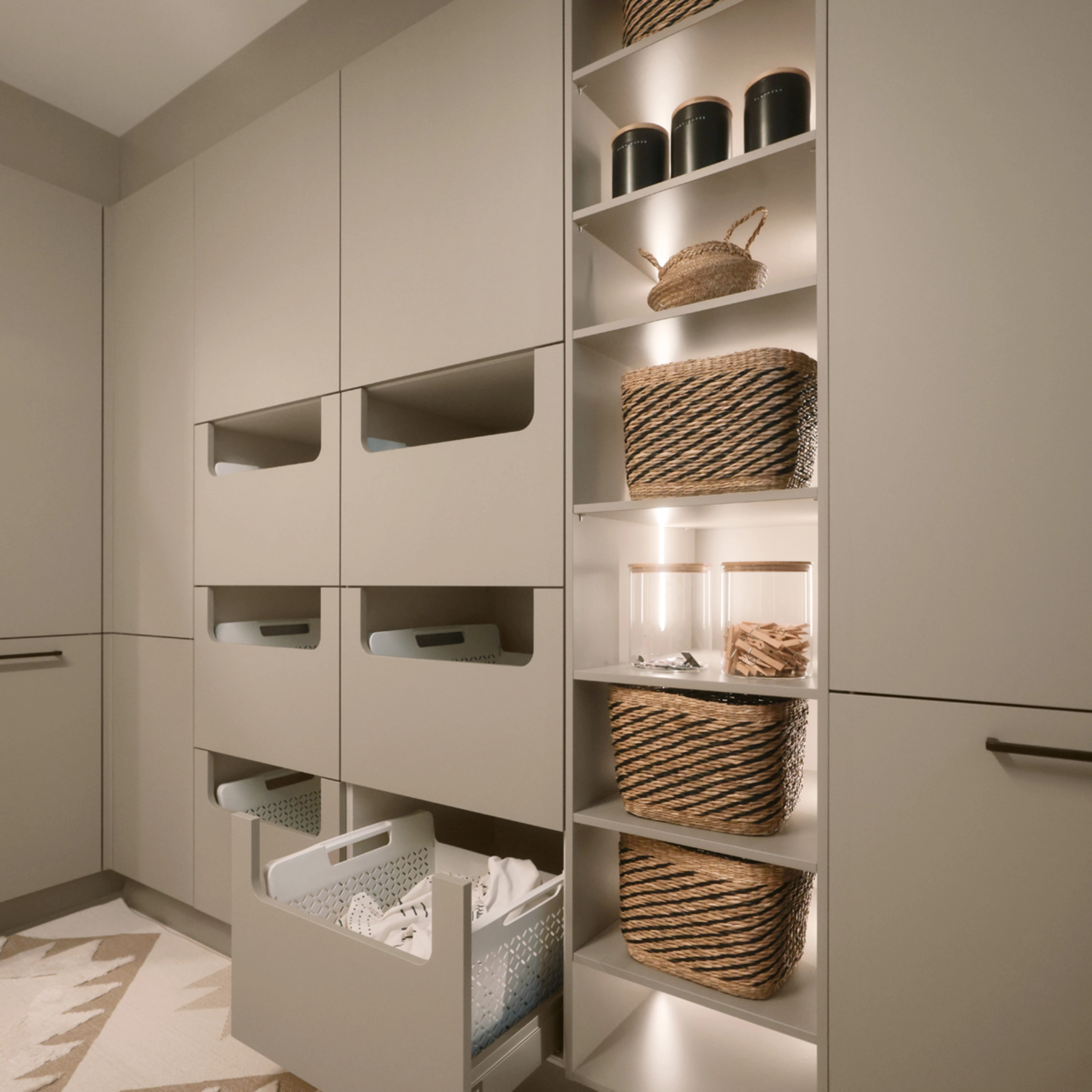 Een bijkeuken met open planken en laden vol manden, gepresenteerd door Nolte Bijkeukens.