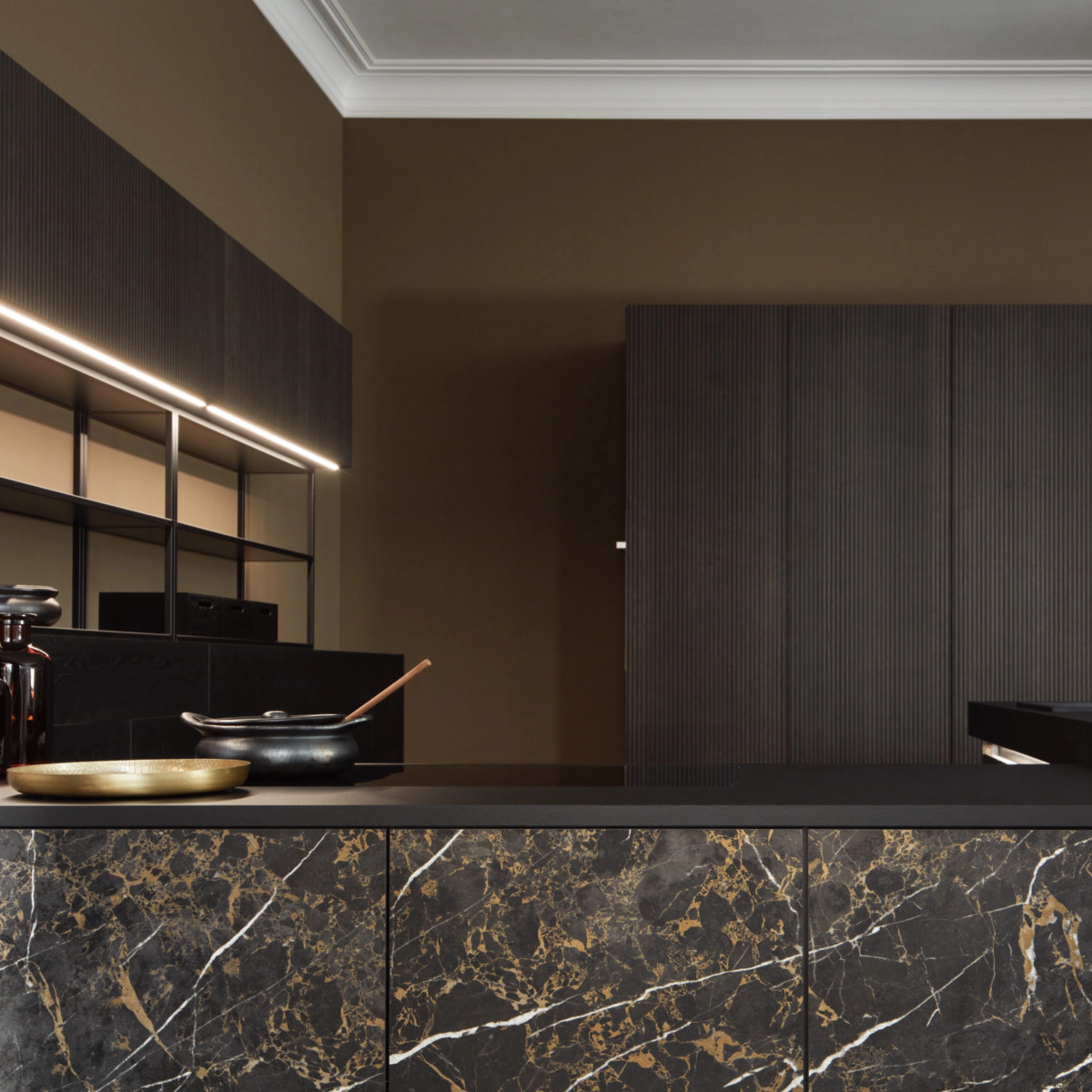A modern kitchen with dark wood and marble elements by Nolte Kitchen.