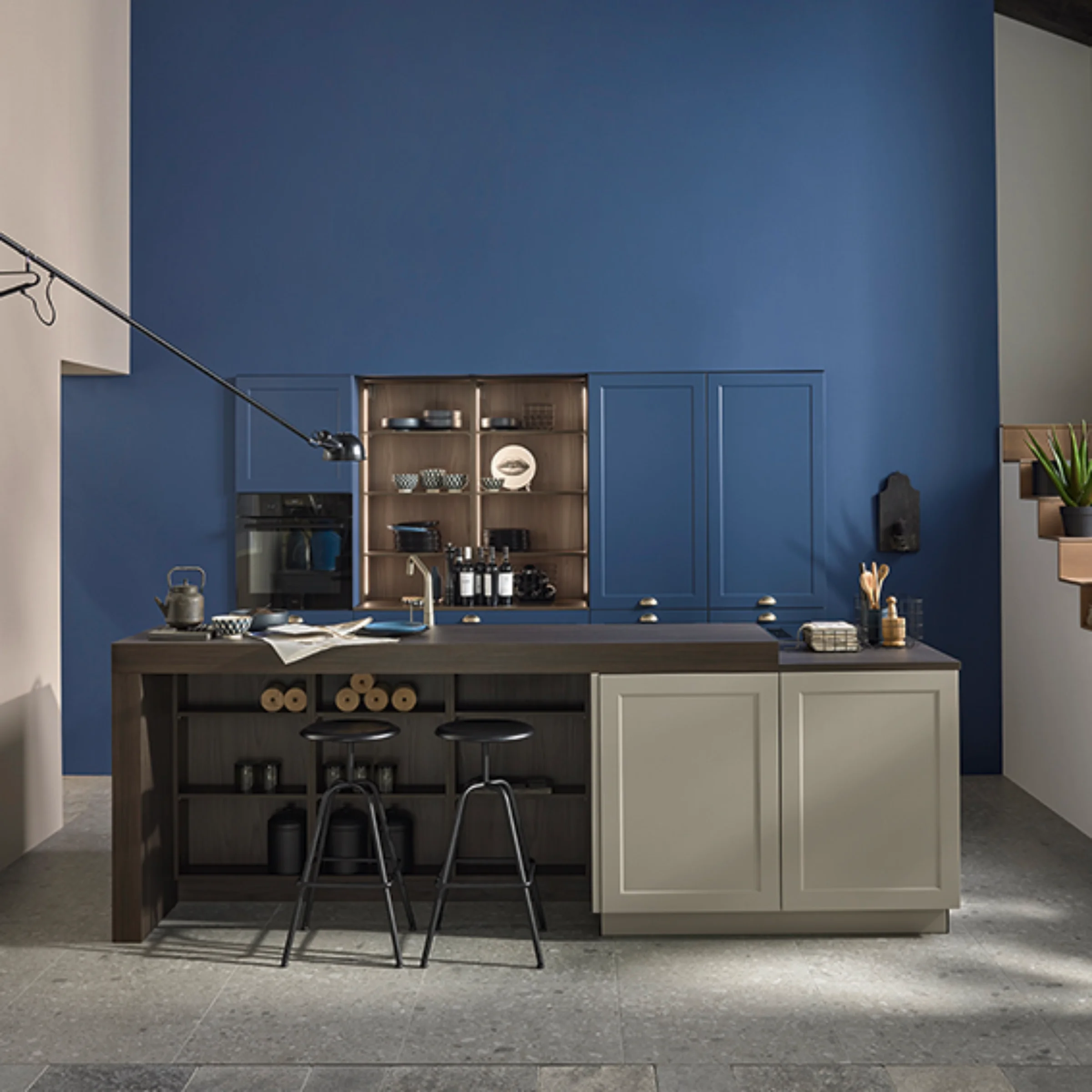A modern kitchen with a blue wall and island. Nolte Küchen.