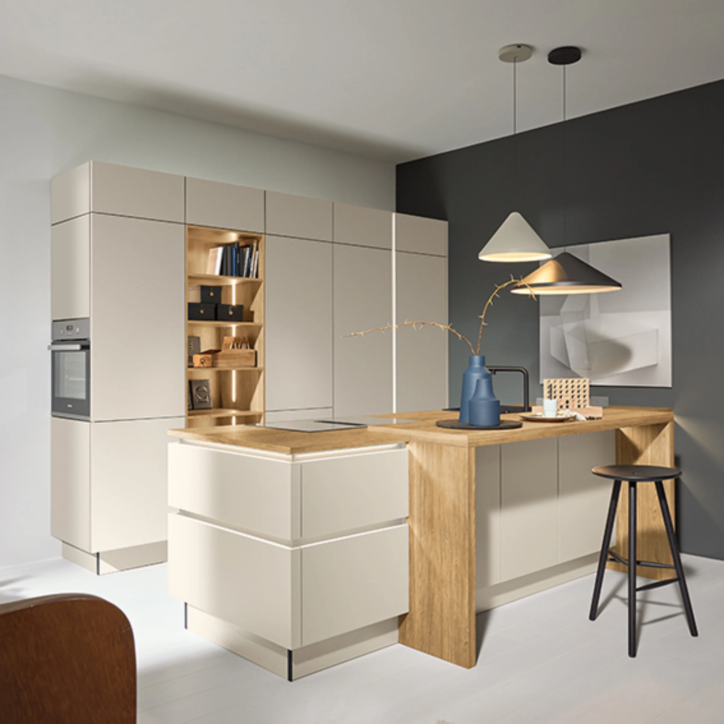 A modern, bright kitchen with an island and stylish lighting. Nolte Kitchens.