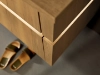 Een elegant houten badkamermeubel met slippers op de vloer, Nolte SPA.